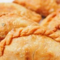 Curry Puff · Sweet potatoes, onions mixed in curry powder wrapped and deep-fried until crispy brown. Serv...