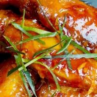 Chicken Wings · (Plain or Spicy). Marinated crispy chicken wings served over spicy and sweet sauce.