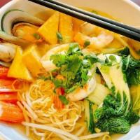 Seafood Noodle Soup · Yellow noodle with a combination of shrimp, imitation crab meat, fish tofu, bean sprout, Bok...