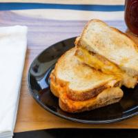 Gourmet Grilled Cheese · Toasted sourdough bread, melted American, cheddar & pepper jack cheese, sliced tomato and Di...