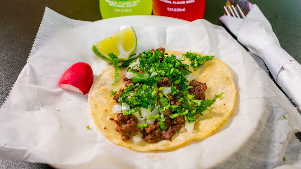 Carne Asada / Beef Tacos · Topped with cilantro and onions. Choice between flour or corn tortilla.