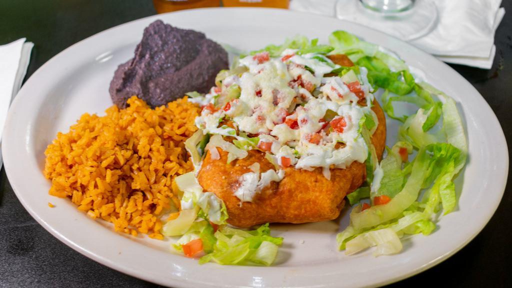 Chimichanga · Fried flour tortilla stuffed with cheese, beans, your choice of meat, topped with sour cream, tomato, cheese, and guacamole. Served with a side of rice and beans.