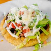 Sopes · Corn dough topped with your choice of meat, beans, lettuce, cilantro, onions and tomato.