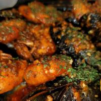 Mussel Supreme  · Mussels cooked in house special garlic butter sauce with sautéed shrimps, corn on the cob an...