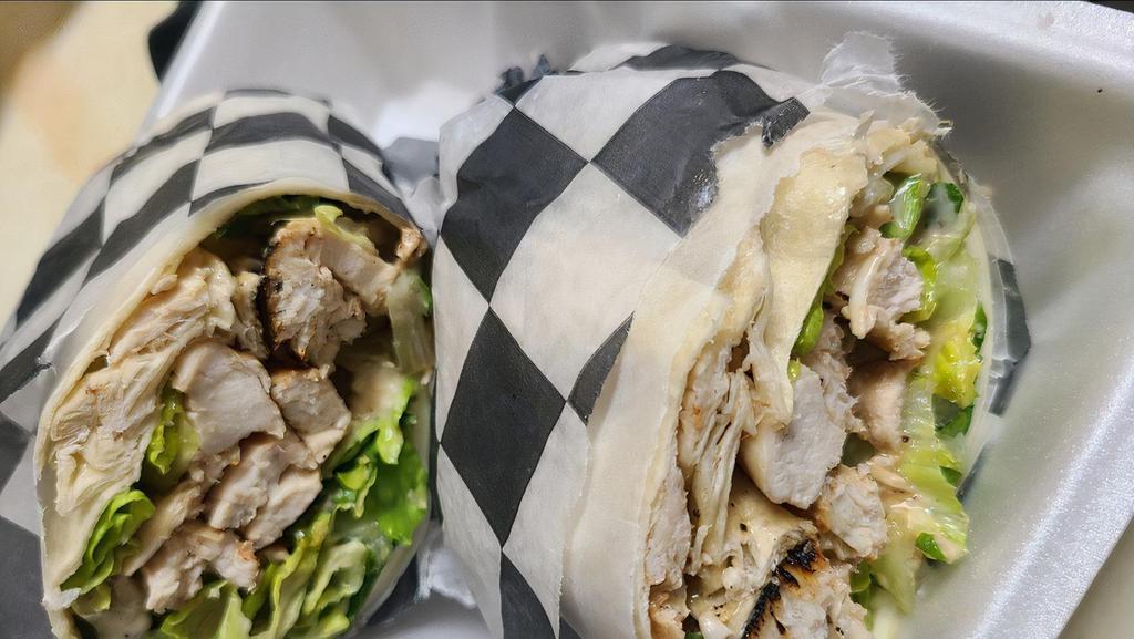 Chicken Caesar Wrap · Marinated grilled chicken, romaine, caesar dressing, provolone, and parmesan cheese.
