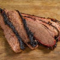 Sliced Brisket · Texas style brisket, black pepper rubbed and smoked for 18 hrs. Hand Sliced.