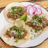 Carnitas Taco  · Slow cooked pork, corn tortilla, cilantro & onion.  Served with lime and radish.