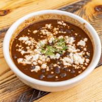 Black Beans · Black beans spiced with arbol peppers. Topped with cotija cheese (Vegetarian)