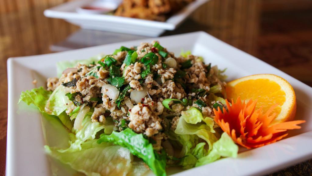 Larb Kai/Thai Chicken Salad · Minced chicken tossed with scallions, red onion, mint leaves, cilantro, ground roasted chilli and lime juice