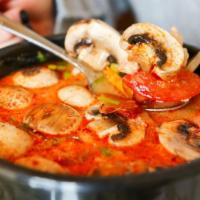 Tom Yum Soup · Famous hot and sour soup, spiced with chilli, cilantro, lemon grass, onion, mushrooms, cocon...