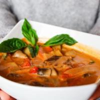 Red Curry · Spicy red curry sauce with coconut milk, bamboo shoots, mushrooms, green peppers and basil w...