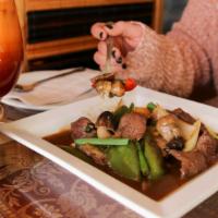 Pepper Steak · Tender slices of beef sautéed with red and green bell pepper, onion, scallions and mushrooms