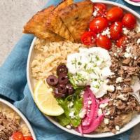 Beef & Lamb Gyro Bowl · Well marinated tender lamb and beef on a bed of fluffy rice, crispy chickpeas and a garden s...