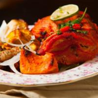 Tandoori Chicken · Chicken with bone marinated in special tandoori spices and grilled, served with sautéed pepp...