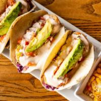 Shrimp Tacos · Pan-seared shrimp served with sweet purple slaw, pico de gallo, fresh avocado topped with ch...