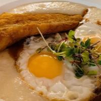 Fried Fish And Grits · Classic etouffee sauce and sunny side up eggs