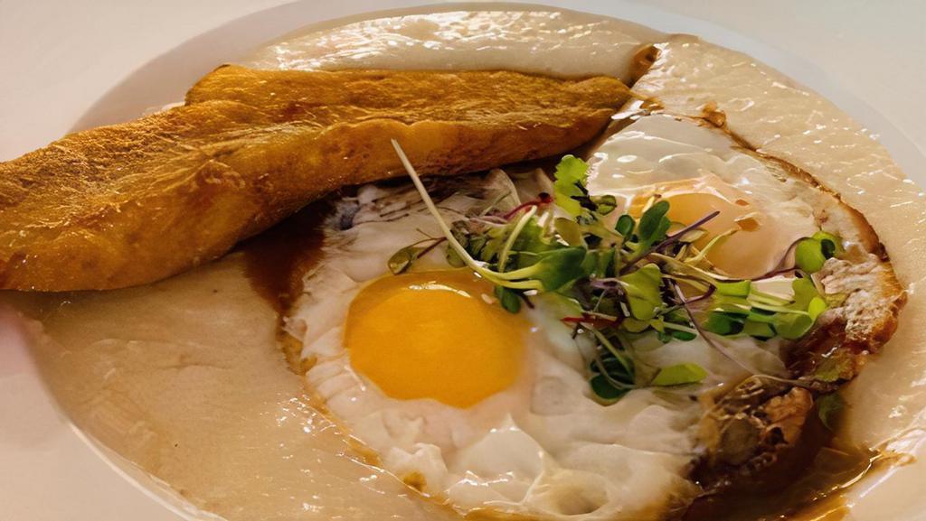 Fried Fish And Grits · Classic etouffee sauce and sunny side up eggs