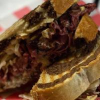 Pastrami Rachel · Thin sliced angus pastrami, swiss cheese, homemade thousand island & slaw grilled on marble ...