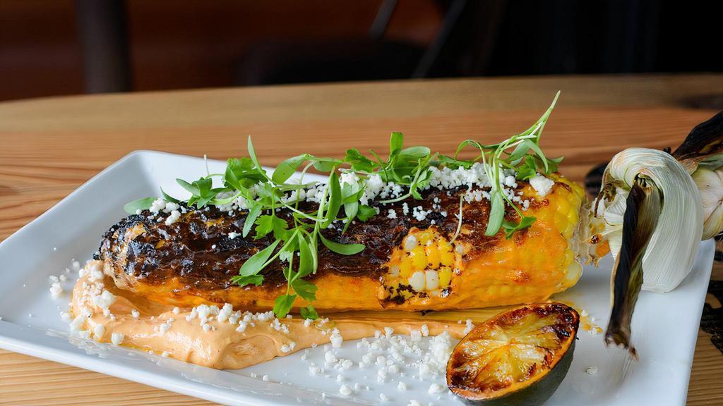 Street Corn (Elotes) · wood fired Jersey fresh corn on the cob, chipotle lime aioli, queso fresco, fresh cilantro, grilled lime wedge