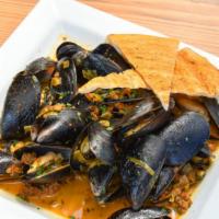 Spanish Saffron Mussels · Maine mussels, chorizo saffron broth, grilled pizza
bread, fresh parsley