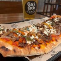 Cheesesteak Flattie · Pizza Sauce, Shaved Ribeye, Onions and Peppers.
