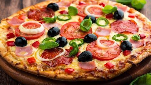 Greek Style Pizza · Feta cheese, black olives, tomatoes, onions, green pepper, and fresh garlic sauce.