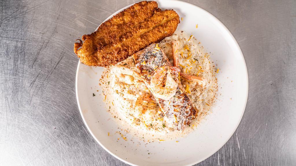 Party Grits  · Jumbo shrimp, fresh Chilean salmon, and lump crab served over creamy grits with jack cheddar shreds, scallions, and our signature scampi sauce. With a side of fried fish.