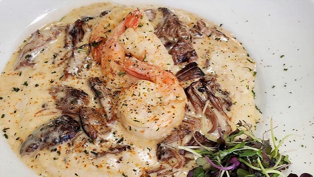 Shrimp & Grits  · jumbo shrimp, sautéed in our signature creamy scampi sauce.