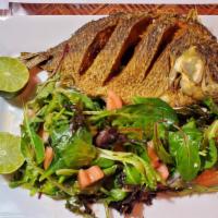 Whole Fish · Well fried tilapia fish with lemon with salad side.