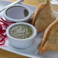 Vegetable Samosa (2 Pieces) · Homemade turnovers stuffed with diced potatoes and peas, flavored with spices. Served with m...