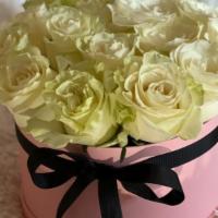 1 Dozen Boxed Roses  · 1 dozen roses delicately arranged in a pink or black. hat box