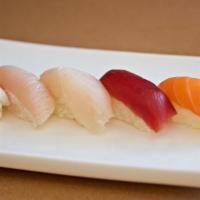 Nigiri Combo · Chef choice of assorted filet of raw fish on rice ball with a spicy tuna maki.
