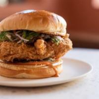 Crispy Chicken Sandwich · Dill pickled cabbage, fermented chile sauce, house pickles, and challah.