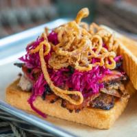 Pork Belly Pastrami · Texas toast, BBQ aioli, crispy shallots, fermented red kraut, and house pickles.