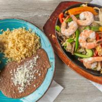 Fajita Combo · Peppers, onion with shrimp and delicious beef and chicken on a side of rice and beans and gu...