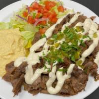 Beef Shawarma Lunch · Beef Shawarma over rice with tahini sauce and pickles. Served with hummus, salad and pita br...