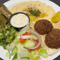 Mezze Plate · 2 pieces of falafel with tahini sauce, 2 pieces of dolma, hummus, tabouli and salad with pit...