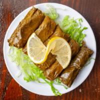 Stuffed Grape Leaves · Five grape leaves stuffed with rice, currants, pine nuts, parsley, onions, and herbs.