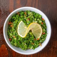 Tabulih · Bulgur wheat mixed with parsley, red and green bell peppers, scallions, tomatoes and olive o...