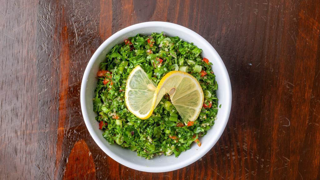 Tabulih · Bulgur wheat mixed with parsley, red and green bell peppers, scallions, tomatoes and olive oil with lemon juice and vinegar.