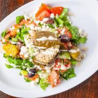 Greek Salad · Lettuce, tomatoes, cucumber, onions, olives, stuffed grape leaves, feta cheese, pickled pepp...