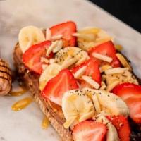 Toasted Nut Toast · almond butter, nutella, banana, strawberry, almond, chia seeds & drizzles with honey