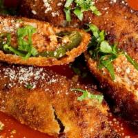Jalapenos Maria Luisa · Breaded Jalapeno peppers filled with shredded chicken and served over a bed of red sauce