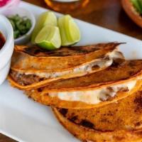 Tacos De Birria · Three Beef Birria on a crispy red flavorful tortilla with melted mozzarella cheese. Served w...
