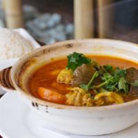 Ga Cari · Spicy. Bone in chicken, potatoes, onions and carrots simmered in a curry and coconut milk br...