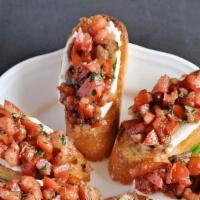 Bruschetta · Four slices of Italian bread toasted and topped with chopped marinated tomatoes, fresh basil...