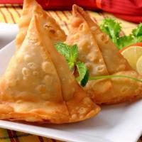 Vegetable Samosa (2 Pieces) · Deep-fried crispy turnovers stuffed with mildly spices potatoes and green peas, served with ...