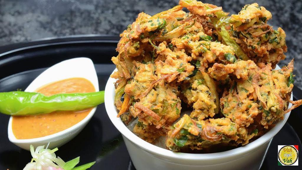 Mixed Vegetable Pakoda · Deep-fried mix of fresh vegetables coated in a mildly spiced chickpea flour batter, served with mint and tamarind chutney.