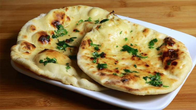 Butter Naan · Soft, fluffy buttered bread baked in clay oven.