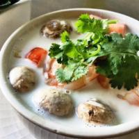 Tom Kha · Traditional Thai style hot and sour galangal soup with mushroom tomato and cilantro. Add shr...